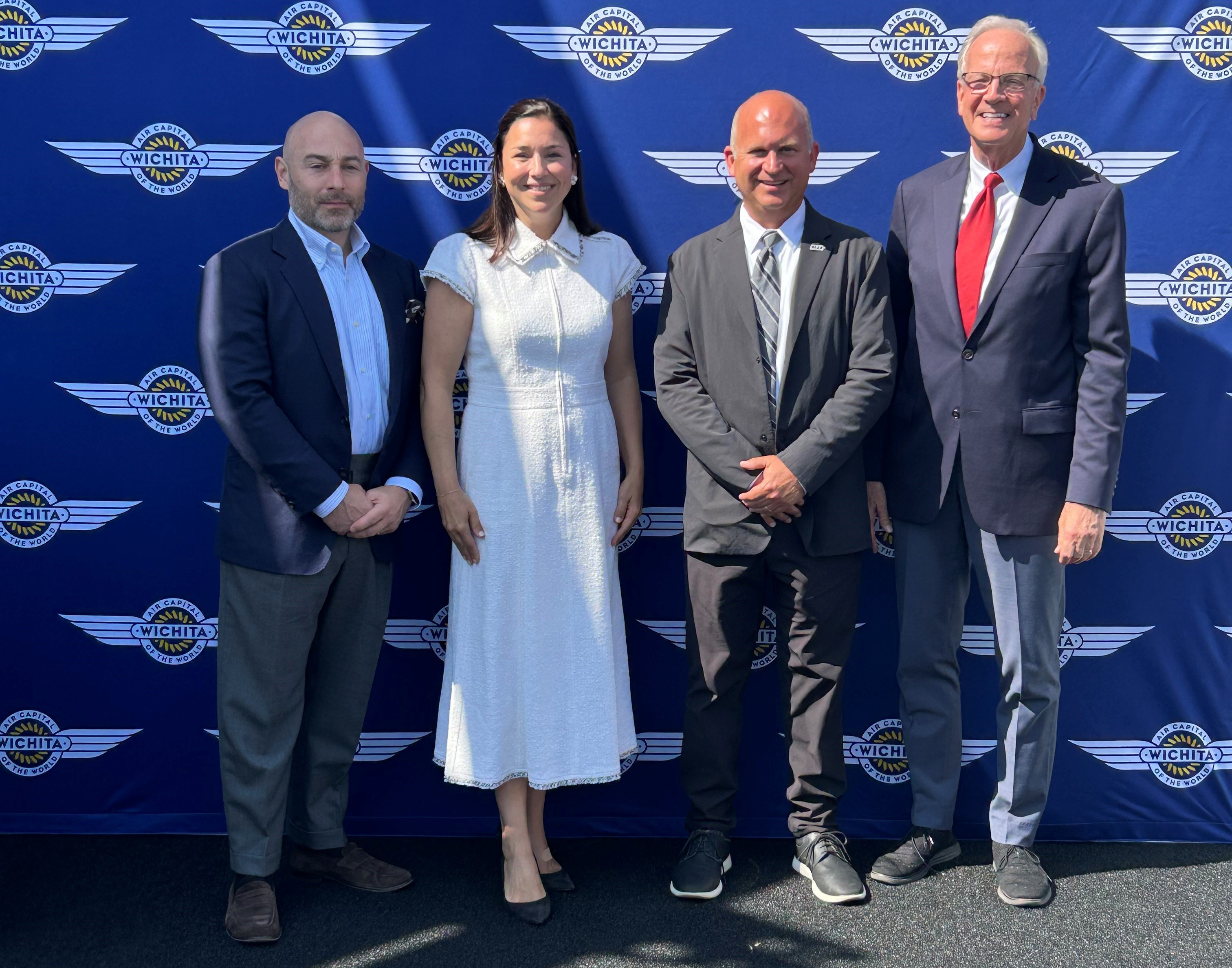Caroline Canfield, founder and CEO of Ad Astra Sky Supply, seen smiling for the camera in celebration of her company's launch at the 2025 Paris Air Show, along with John Tomblin, WSU executive vice president for Research and Industry and Defense Programs; and Kansas Senator Jerry Moran.